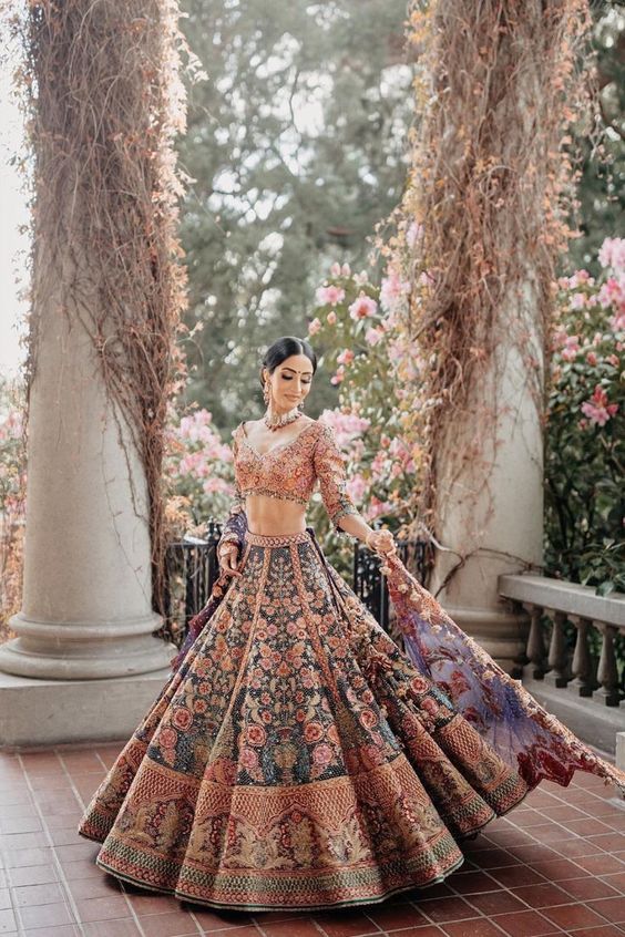 standing beautifully pose in the center of the picture so that the whole  lehenga is visible