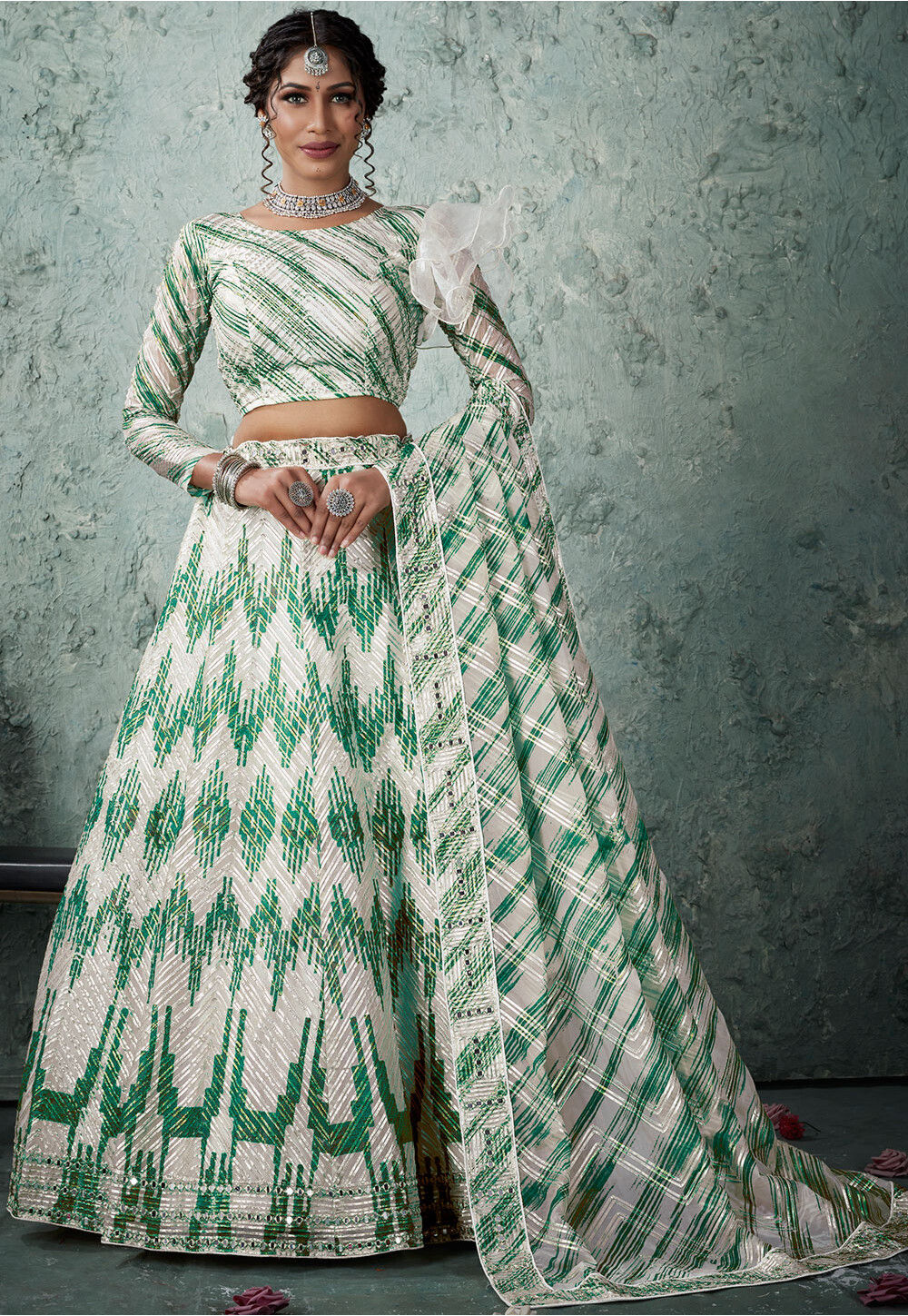 IVORY WHITE CLASSIC LEHENGA SET WITH AN OVER CONTRAST MULTI COLOURED  EMBROIDERY AND 'ABLA' PAIRED WITH A MATCHING DUPATTA AND SILVER  EMBELLISHMENTS. - Seasons India