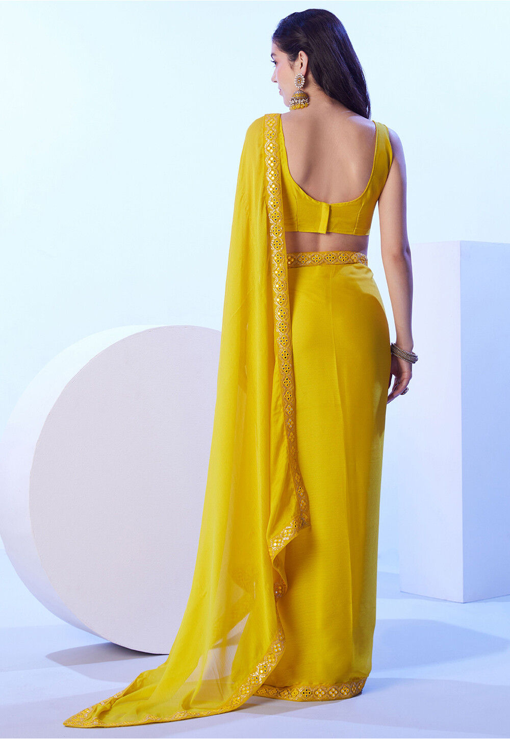 Yellow/white chiffon saree with border mirror work- stitched sleeveless blouse