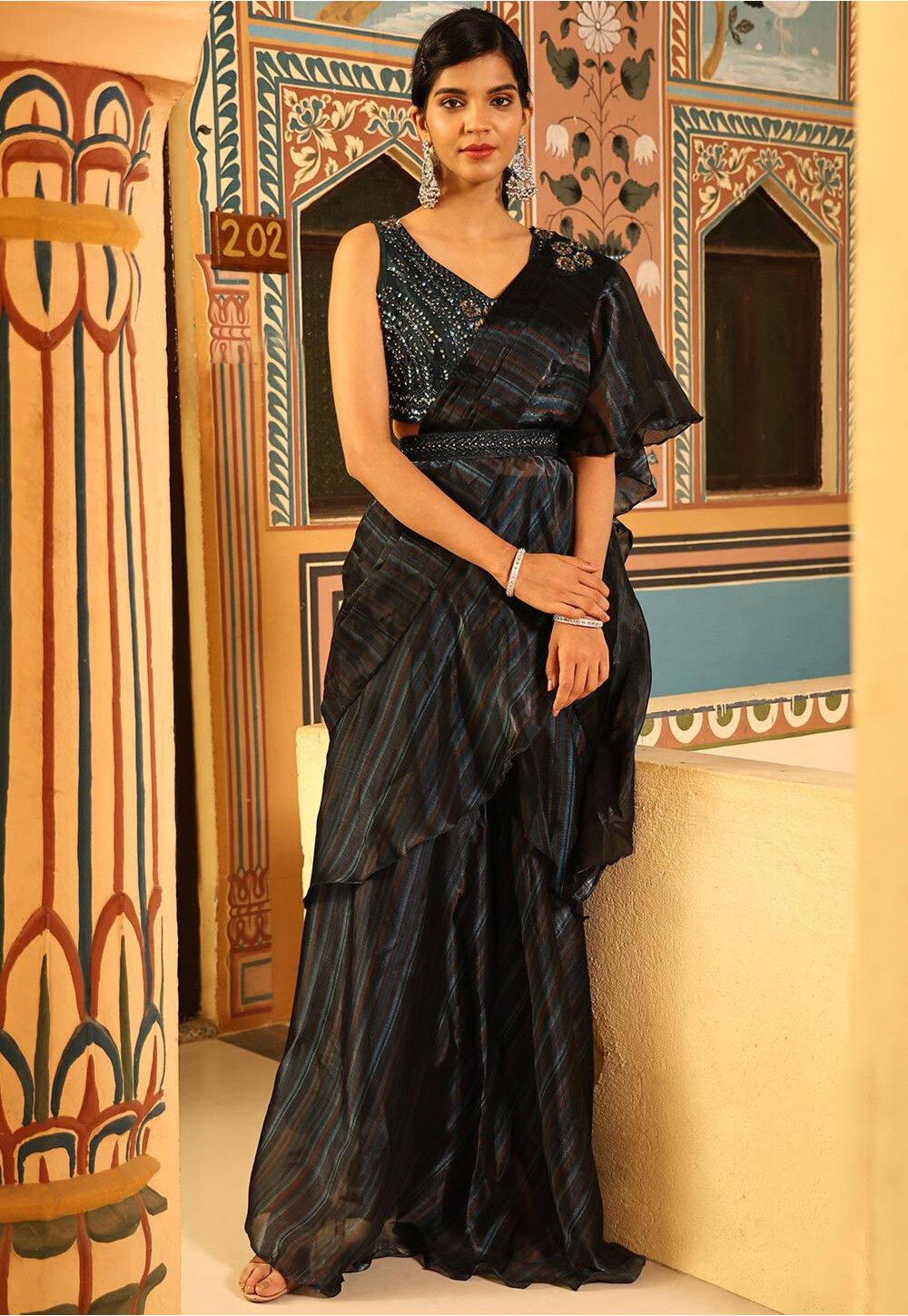 Black pre-stitched saree with gold boota print in georgette.