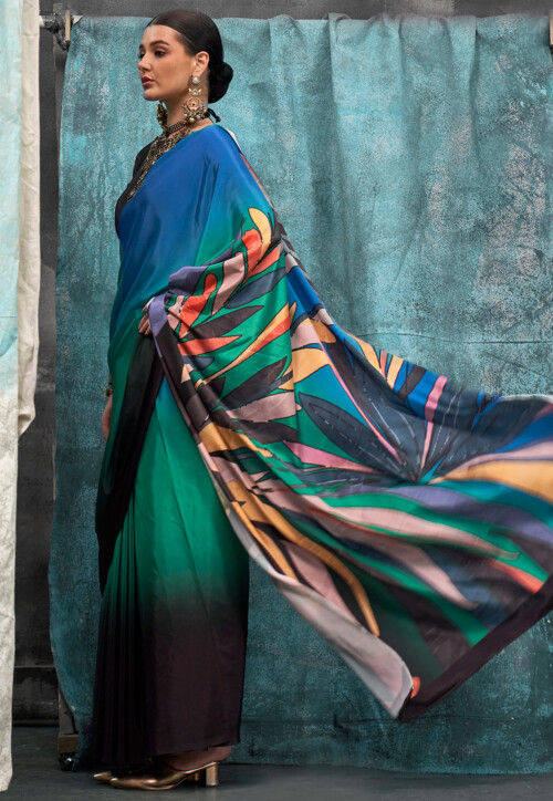 Cream leaf motifs printed crepe silk saree, contrast blue printed blouse, kaleidoscope coloured intricately printed border & pallu