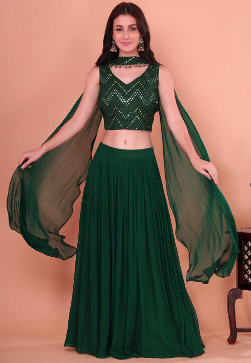 Shyna Design Studio - Monika looks resplendent in a brocade cropped  shirt-blouse and a box pleated lehenga in rich emerald green! It's a 👍all  the way! Thank you for sharing the picture
