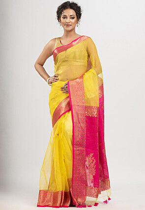 Photo of South Indian bride in a lime green and yellow saree.